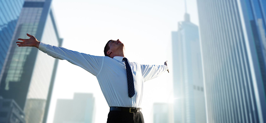 happy young businessman and big city